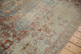 Distressed antique Soumac carpet with worn pile, visible foundation, red and blue patterns.
