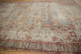 Antique Distressed Soumac carpet showing wide geometric border, worn pile, exposed foundation, red, blue, beige.