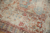 Distressed antique Soumac carpet with exposed foundation, showing cherry red, sky blue geometric designs.
