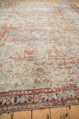 Distressed Soumac carpet texture, faded sky blue and cherry red geometric border motifs.