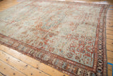 Distressed antique Soumac rug's unusually wide geometric border in cherry red and sky blue.