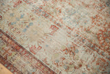 Distressed antique Soumac carpet detail: worn texture, visible foundation, wide geometric border.