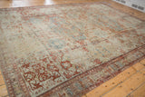 Antique distressed Soumac carpet's wide border, displaying red, blue, beige geometric motifs.