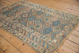 Antique Kurdish rug corner showing fringe, geometric border, and foundation wear.