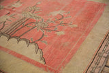 Blush pink pictorial field detail of antique Khotan carpet, ivory mounds, brown blossoms.