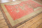 Antique Khotan carpet corner featuring bamboo motif border, even wear, and fringe.