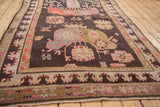 Hand-knotted Khotan carpet border showcasing stylized motifs in mauve, ivory, and peach.