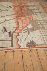 Vintage Khotan carpet's secured bottom edge showing terracotta band and even pile wear.