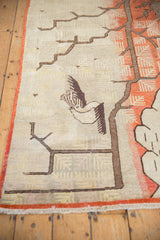 Vintage Khotan rug with pictorial bird and tree, terracotta ground, and even pile.