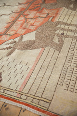 Neutral vintage Khotan rug pile with a terracotta stripe and delicate linear patterns.