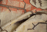 Folded vintage Khotan rug with even pile wear, subtle terracotta and light neutral tones.