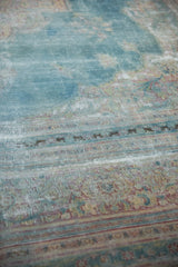 Distressed powder blue Khorassan carpet with worn pile, exposed foundation, and faded patterns.
