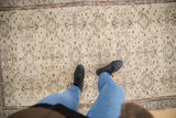 Distressed Vintage Sparta rug featuring faded ivory, silver, and terracotta floral motifs underfoot.