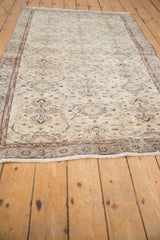 Distressed Turkish Sparta rug, angled view of muted ivory, silver, terracotta floral vinery.