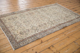Distressed vintage Sparta rug corner, showcasing its decorative faded ivory, terracotta, and slate floral patterns.