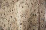 Textured pile of a distressed vintage Sparta rug showing even wear and faded floral details.