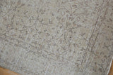 Distressed vintage Sparta rug showing faded ivory, beige vinery and wear to foundation.