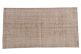 Vintage distressed Sparta rug with an allover trellis design in dusty blush, silver, and ivory.