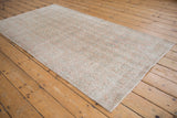 A distressed vintage Sparta runner viewed at an angle, showing its allover texture and soft blush tones.
