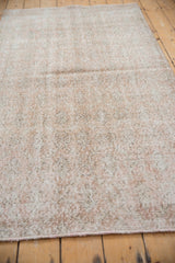 A detailed view of the distressed texture and visible knot heads on the vintage Sparta rug.
