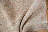 Worn pile of a distressed Sparta rug showing a grid pattern and the ivory foundation.