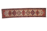 Vintage West Persian rug runner featuring an ivory field and bold red and royal blue medallions.