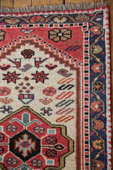 West Persian runner corner with fringe, geometric borders, ivory field starburst motifs.