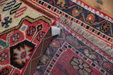 Vintage West Persian runner, folded corner showing starburst-patterned pile, fringe, and tight woven back.