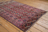 Vintage Turkmen rug showcasing chestnut and magenta elephant footprint guls with abrashes and geometric borders.