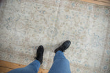 Vintage distressed Sparta rug, showcasing worn foundation and faded scrolling vinery design.