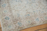 Vintage Distressed Sparta rug showing even wear, visible foundation, and pale blue vinery.