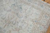 Vintage Distressed Sparta rug showing muted ivory, sand, and pale blue scrolling vinery.