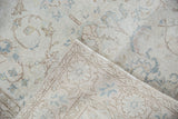 Distressed ivory pile with pale blue vinery motif and reverse foundation of a vintage Sparta rug.
