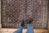 Vintage Malayer rug's allover Herati motif with scrolled leaves, showcasing varied pile.