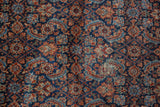 Worn navy and red Herati pattern on vintage Malayer rug, revealing antique ivory foundation.