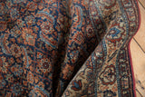 Vintage Malayer rug's Herati design and border detail in navy, rust, sky blue, and ivory.