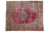 Distressed vintage Persian Doroksh rug with ruby red field, diamond medallion, and Herati borders.