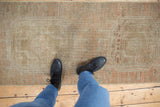 Distressed Oushak runner with abrashed beige, copper, and silver tones, showing even wear.