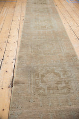 Distressed texture of the Oushak runner, highlighting subtle beige and pale copper medallions.
