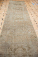Vintage distressed Oushak runner with subtle pattern, even pile wear, and faint foundation.