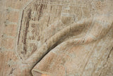 Folded distressed Oushak runner, showing worn low pile texture in beige and brown tones.