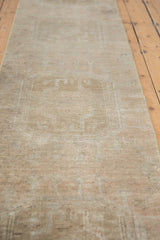 Distressed Oushak rug showing subtle beige medallion pattern and soft, worn pile.