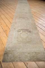 Vintage Distressed Oushak runner's decorative beige pile and muted medallion pattern.