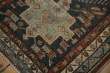 Detail of a vintage Karaja rug's geometric medallion and meandering vine border.