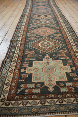 Vintage Persian Karaja runner showing its column of repeating geometric medallions in teal and rust.