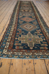 A low-angle view down the length of a vintage Karaja runner showing its repeating medallions.