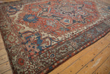 Distressed Serapi rug detail: Samovar turtle border, rust, blue, ivory, with soft vintage wear.