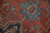 Distressed Serapi carpet pile, rust and blue serrated arabesques with foundation showing.