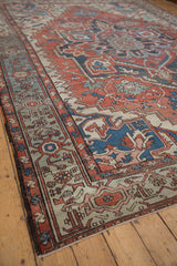 Worn pile and fantastic abrashes define this Serapi rug corner in rust, blue, ivory.