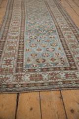 Distressed Caucasian runner with geometric blue field and faded red crab style border.